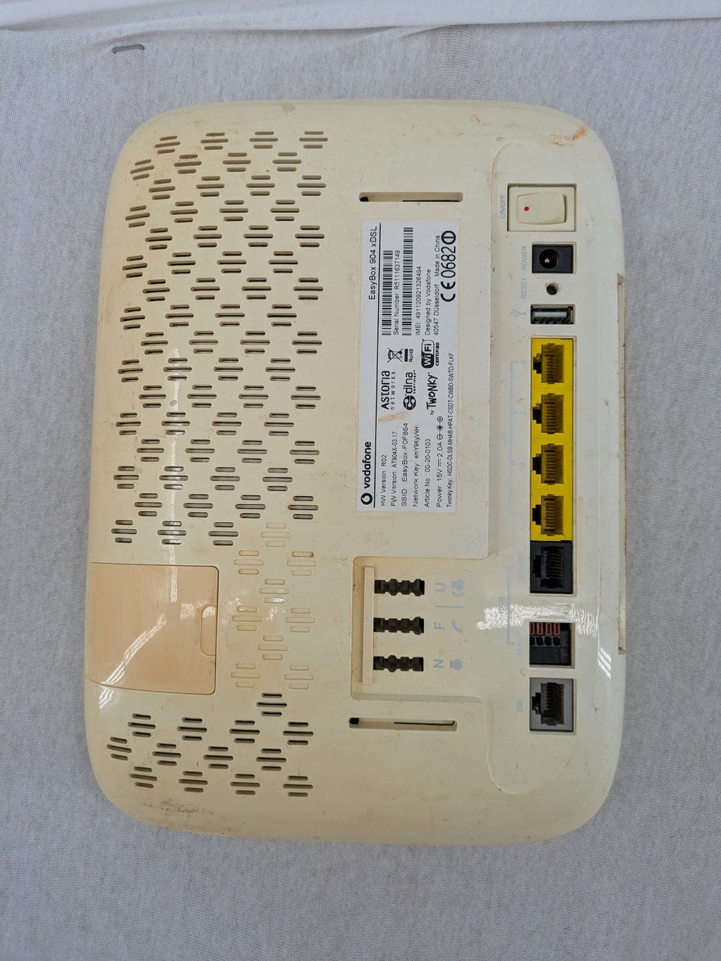 Vodafone wireless router beige and black with multiple LAN ports and USB connection.