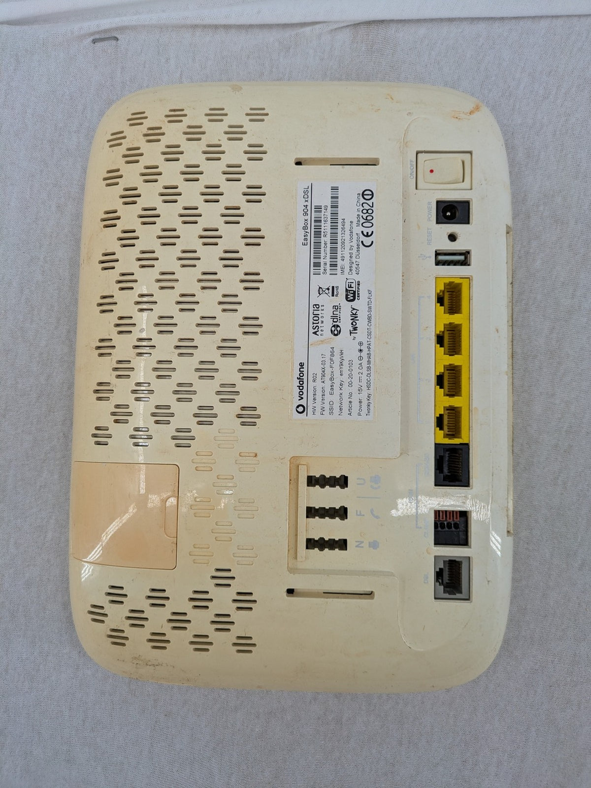 Vodafone wireless router beige and black with multiple LAN ports and USB connection.