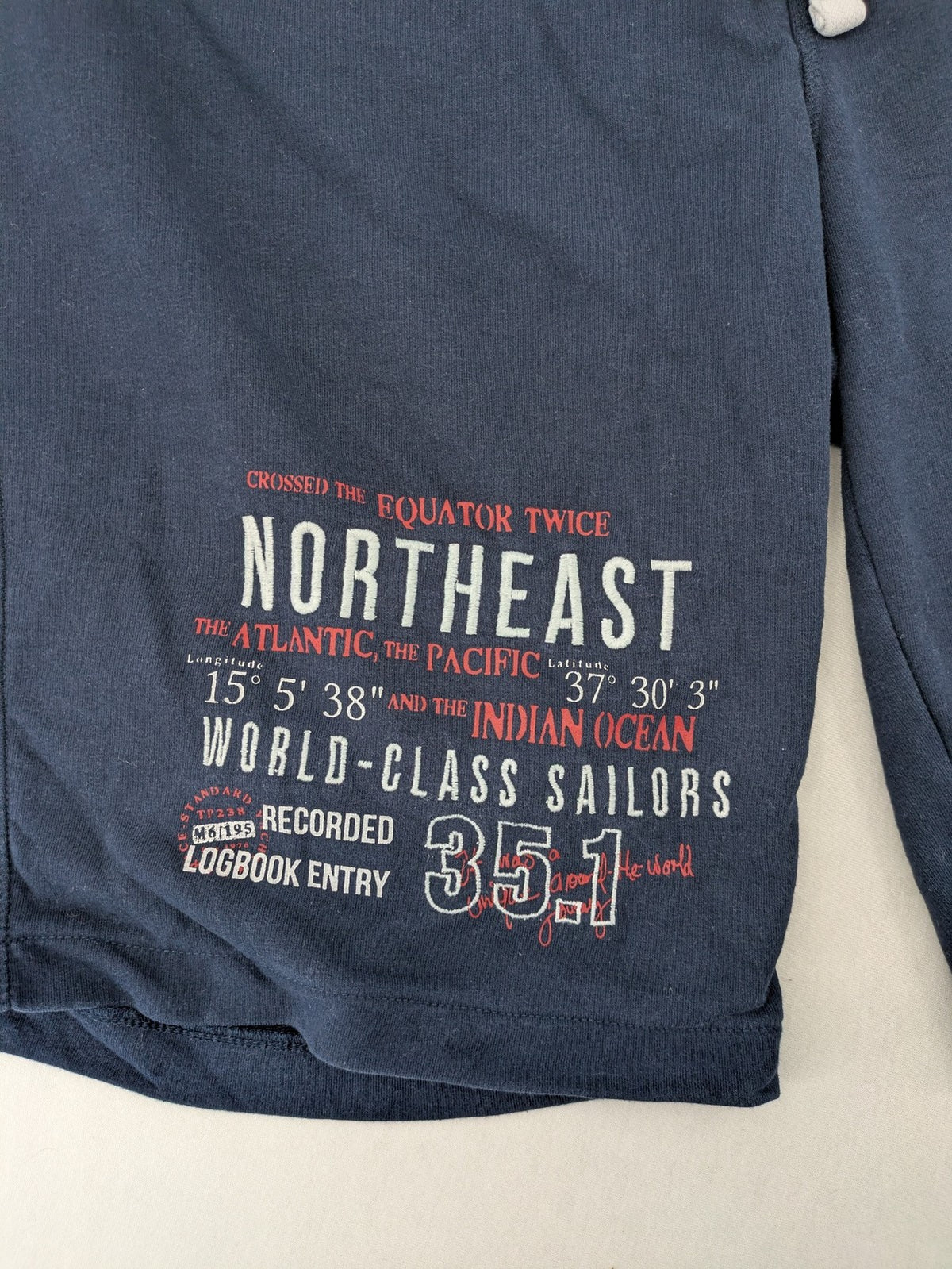 Livergy blue sweatshorts with "Northeast Sailors" graphic print and elastic waistband.