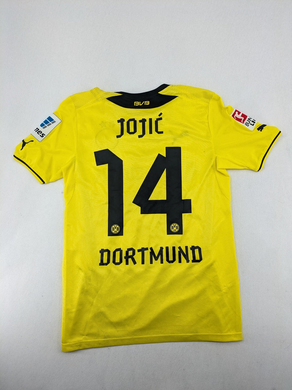 Borussia Dortmund black and yellow soccer uniform with DFB Pokal 2014 patch and Puma logo.
