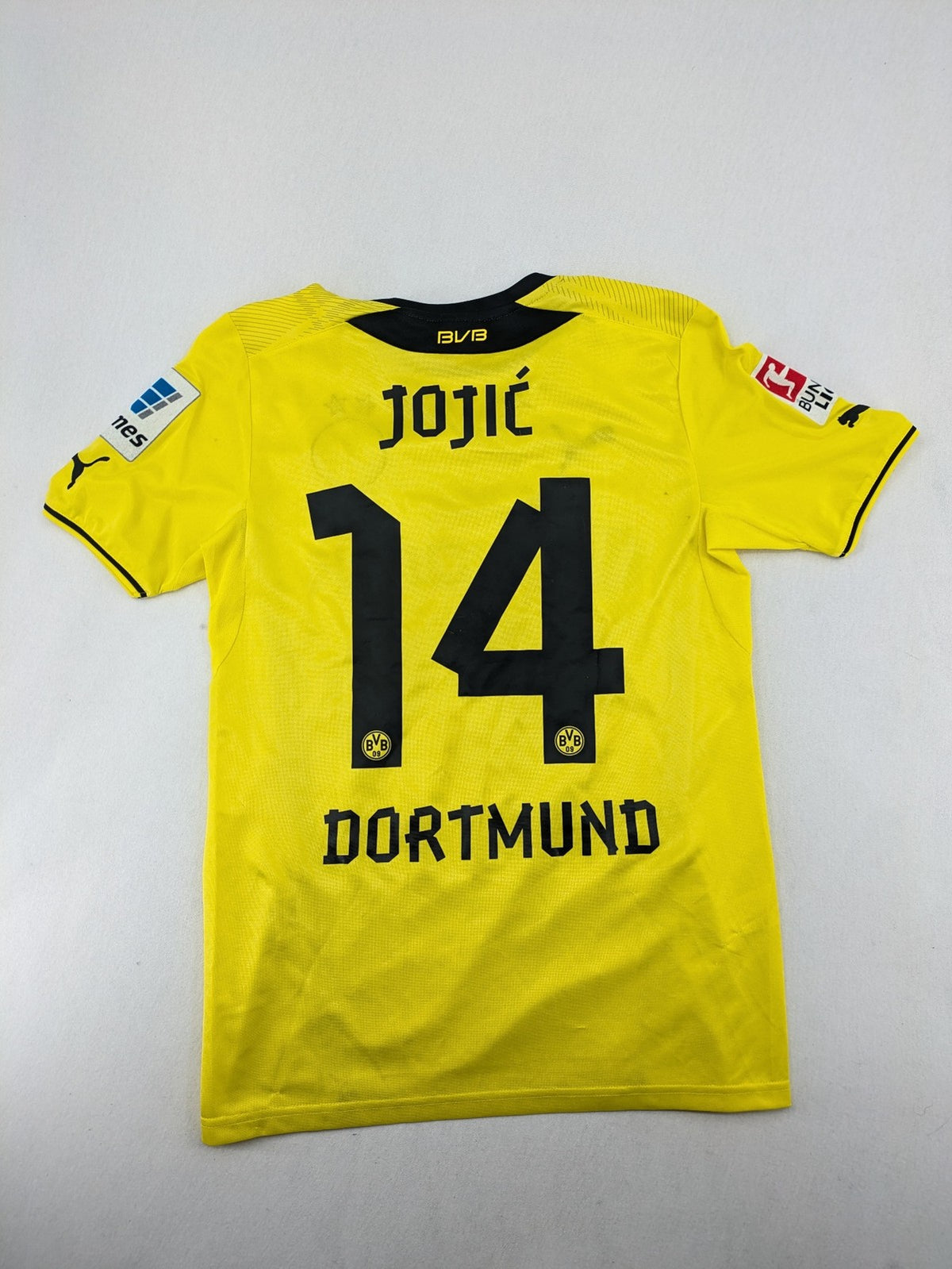 Borussia Dortmund black and yellow soccer uniform with DFB Pokal 2014 patch and Puma logo.