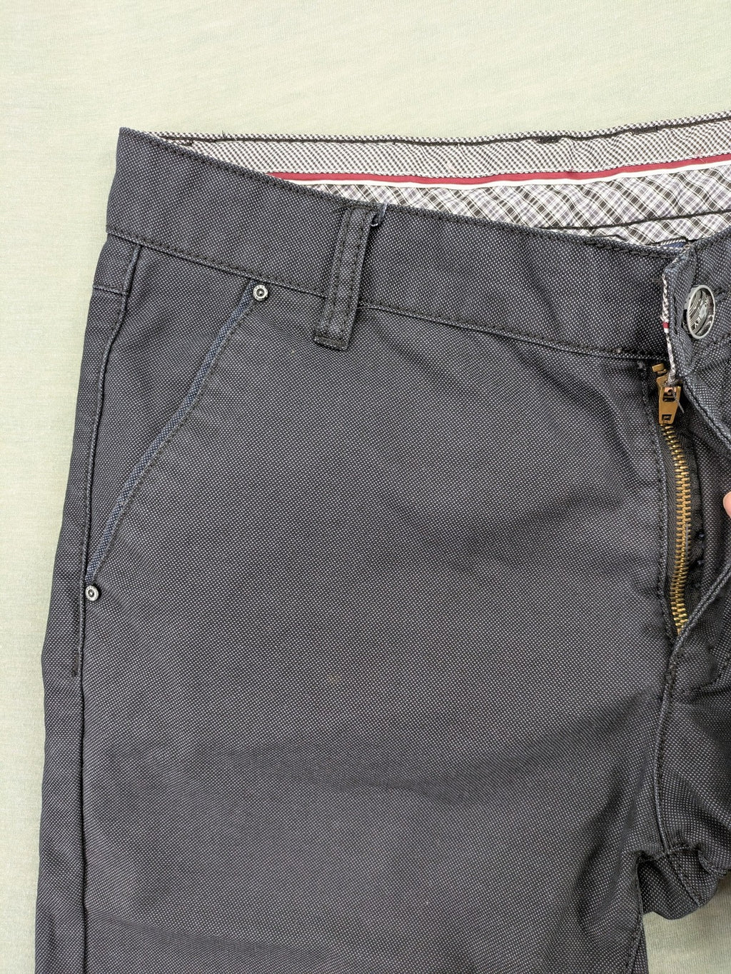 Rooney grey chino pants with checkered waistband and buttoned back pockets.