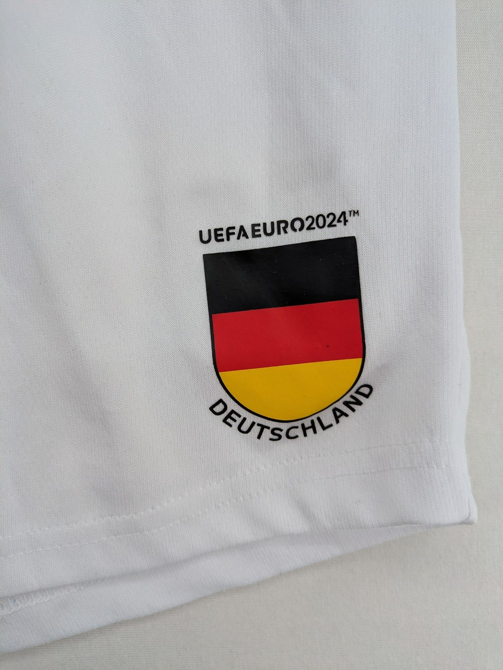 UEFA EURO 2024 white shorts with Germany crest and logo, elastic waistband, breathable material.