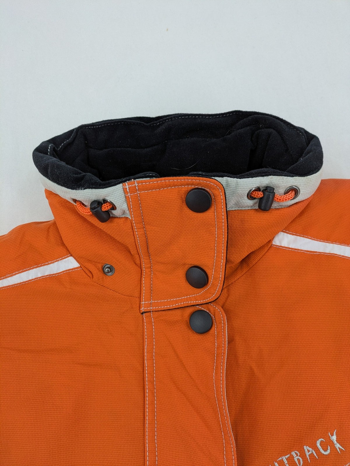 Outback orange outdoor jacket size 42 with reflective accents and mixed color details.