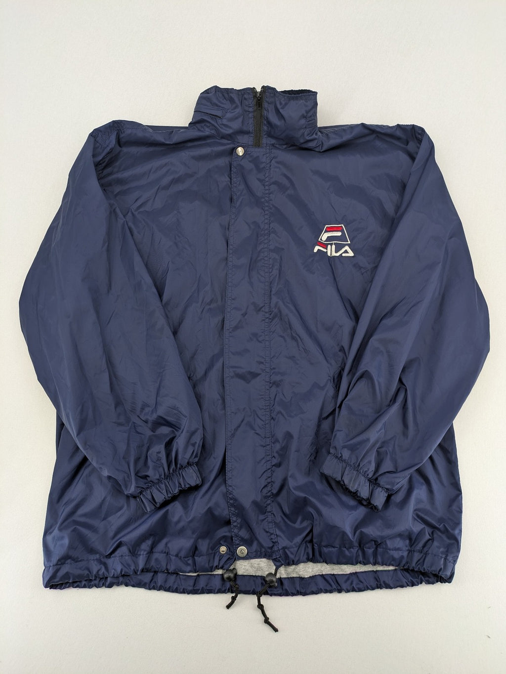 Fila navy windbreaker jacket with large embroidered logo on chest and back.