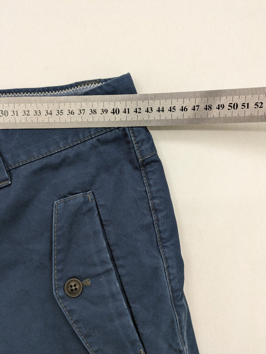 Marc O'Polo blue chino pants with button flap pockets and relaxed fit design.