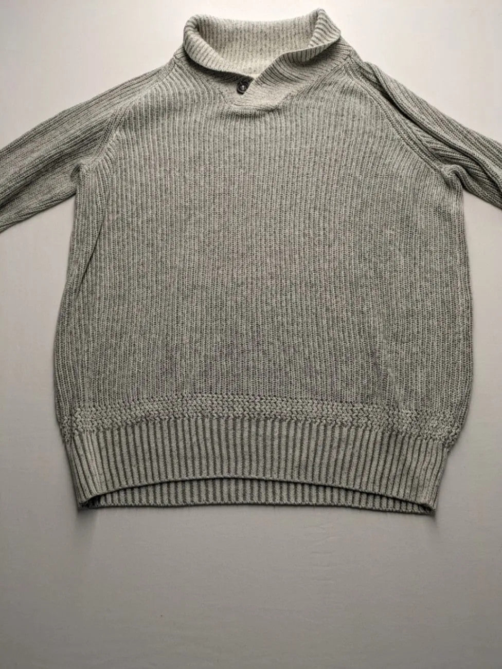 Autumn Glow grey turtle neck jumper with ribbed pattern and button detail.