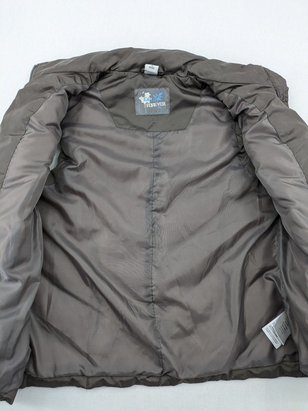 L&A Fashion grey puffer vest with zip closure, stand collar, and side pockets.