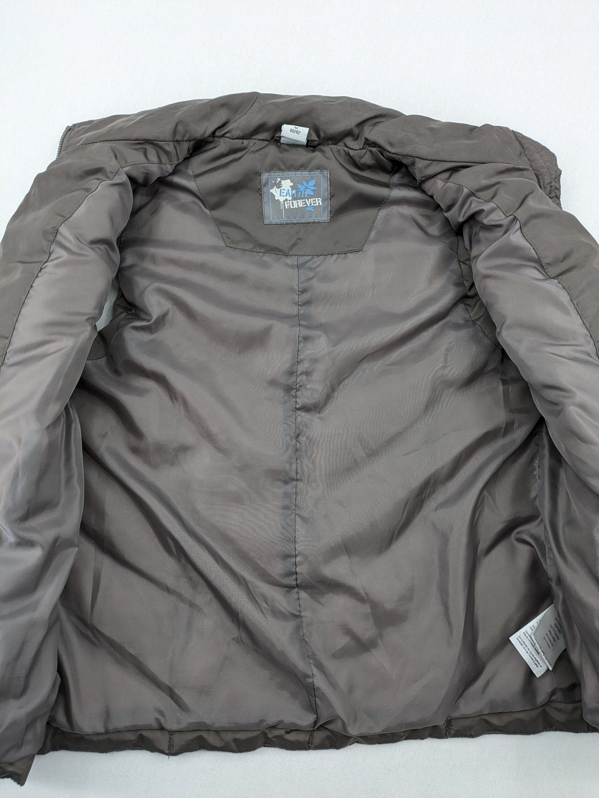 L&A Fashion grey puffer vest with zip closure, stand collar, and side pockets.