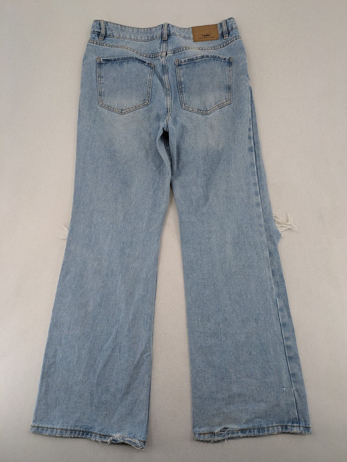 Laulia blue wide leg jeans with distressed knee rips and high waist design.