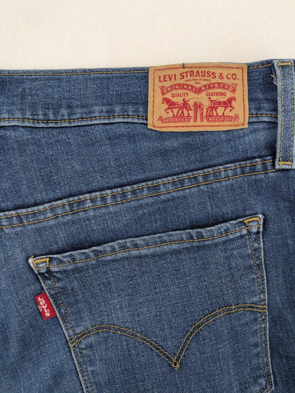 Levi's blue denim Bermuda shorts with rolled cuffs and classic 5-pocket design.