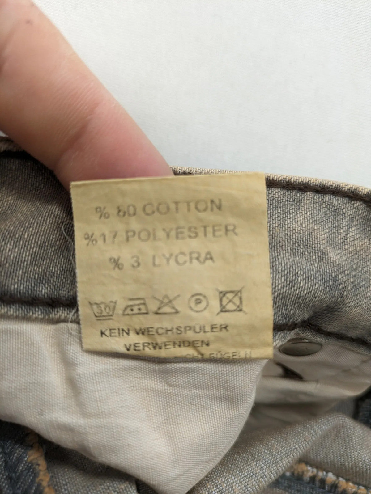 Masha khaki straight jeans with rhinestone embellishments and decorative stitching.