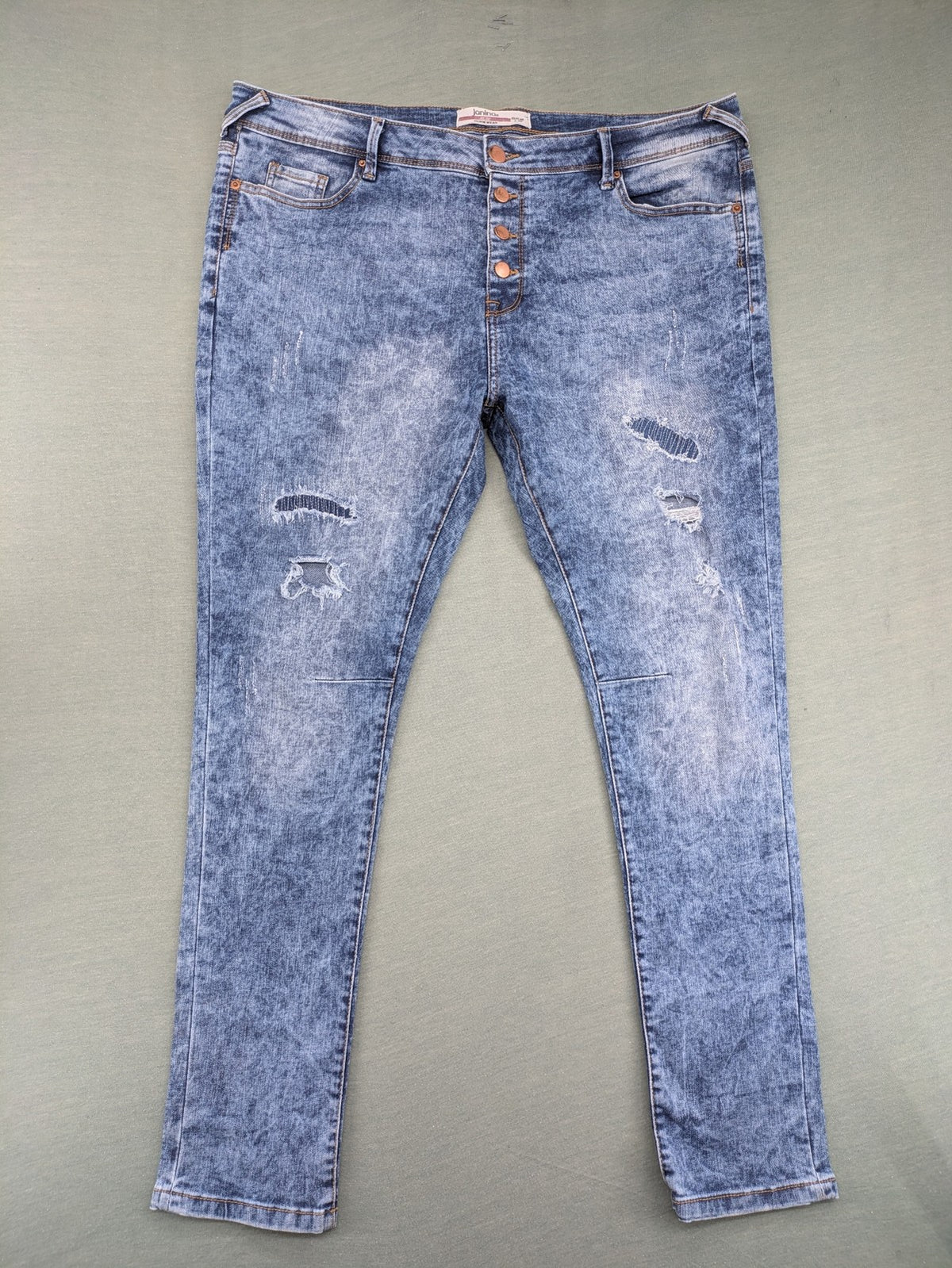 Janina blue slim fit jeans with acid wash, destroyed details, and button fly.