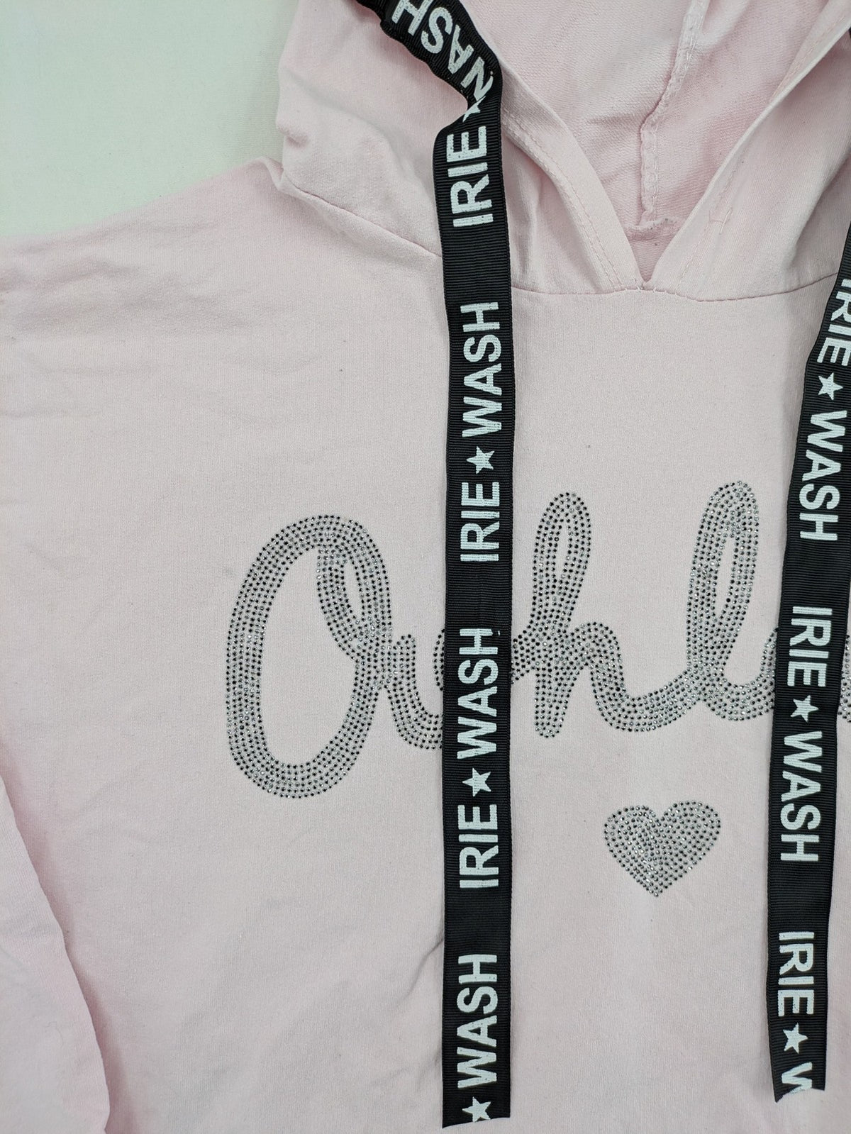 Irie pink turtle neck jumper with "Oohlala" rhinestone lettering and logo drawstrings.