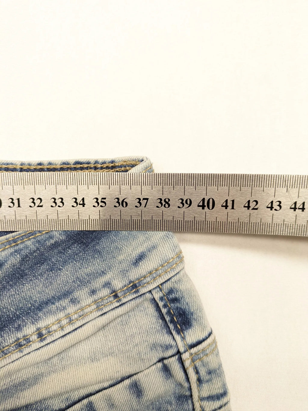 ONE LOVE DENIM blue straight jeans with distressed details and double button closure.