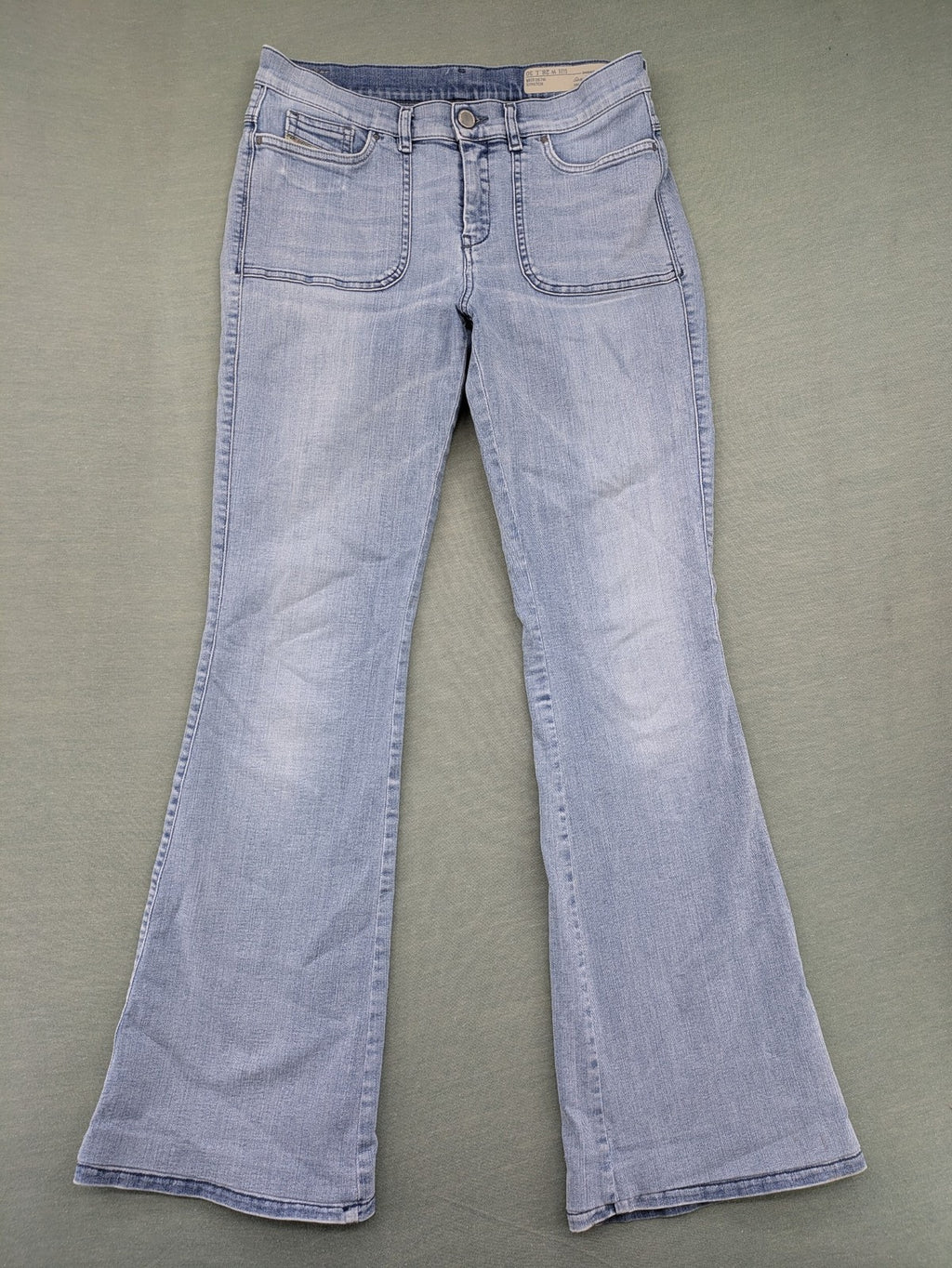 Diesel blue bootcut jeans with white patch pockets and regular waist, stylish stretch material.