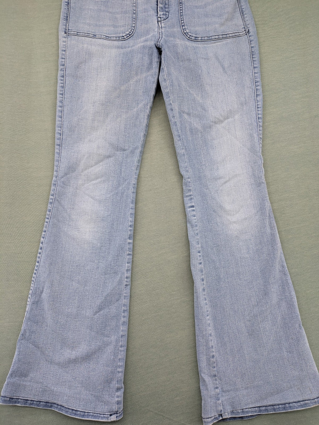 Diesel blue bootcut jeans with white patch pockets and regular waist, stylish stretch material.