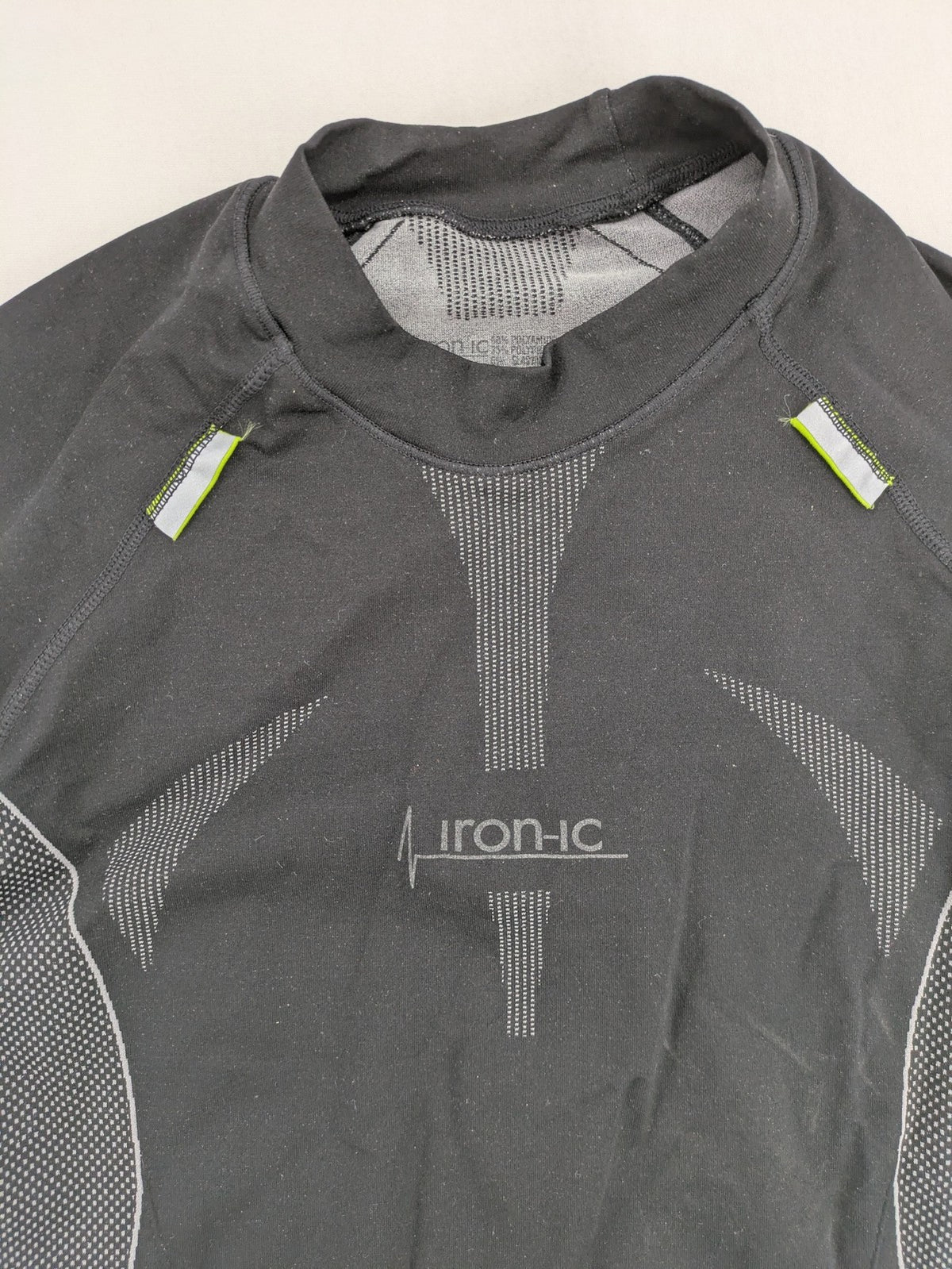 Iron-ic black long sleeve baselayer top with standing collar and thumbholes.