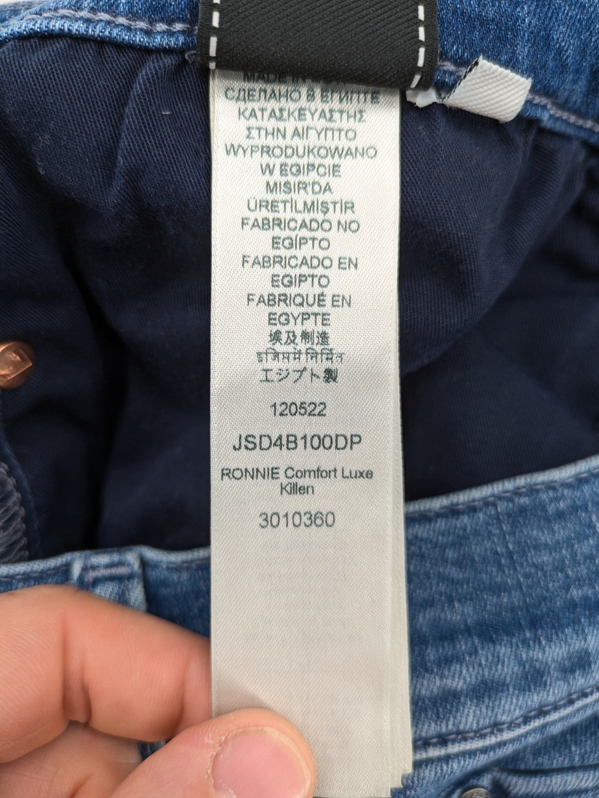 7 For All Mankind blue straight jeans with 5-pocket design and logo on back pocket.
