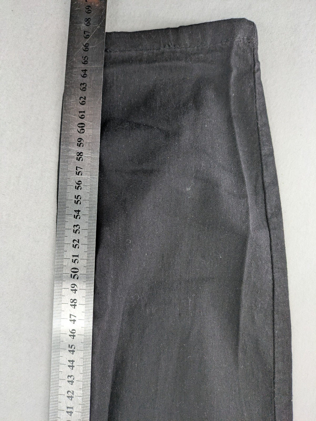 Denim & Co. black straight jeans with front button closure and back pockets.