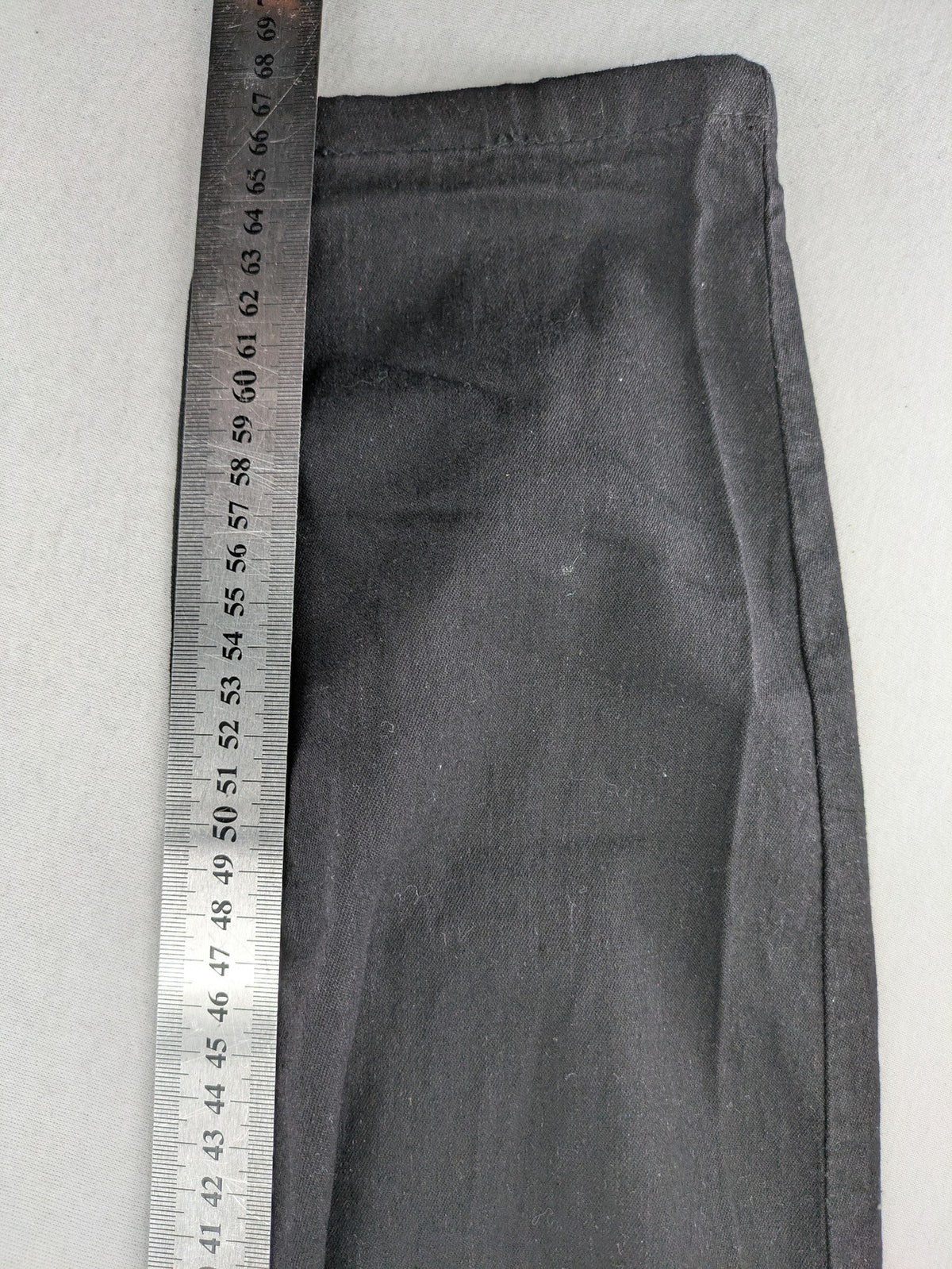 Denim & Co. black straight jeans with front button closure and back pockets.