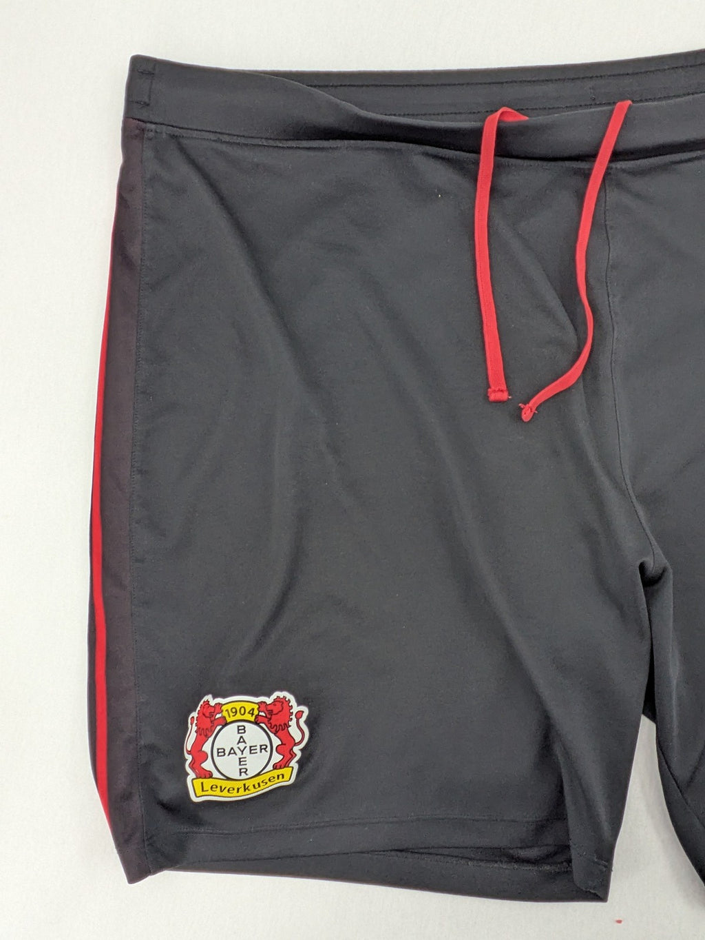 Bayer black training shorts with red side stripes, embroidered team crest and Castore logo.