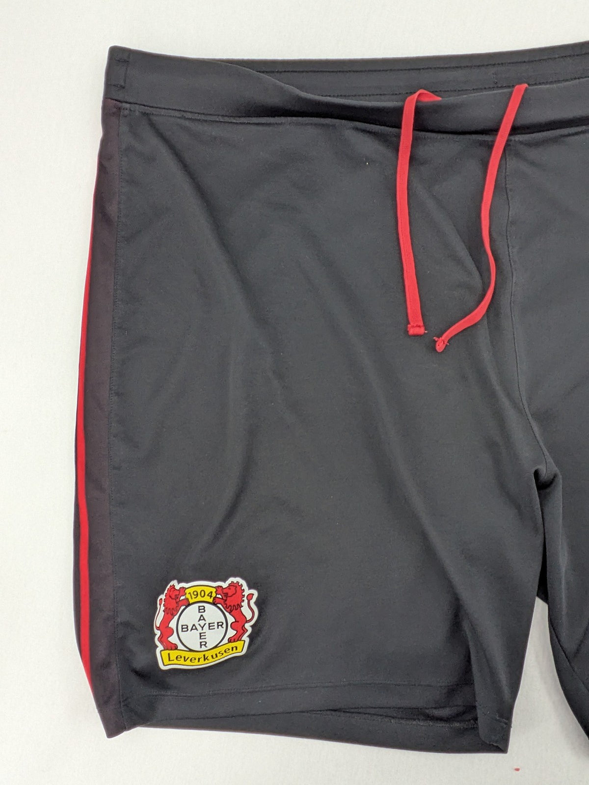 Bayer black training shorts with red side stripes, embroidered team crest and Castore logo.