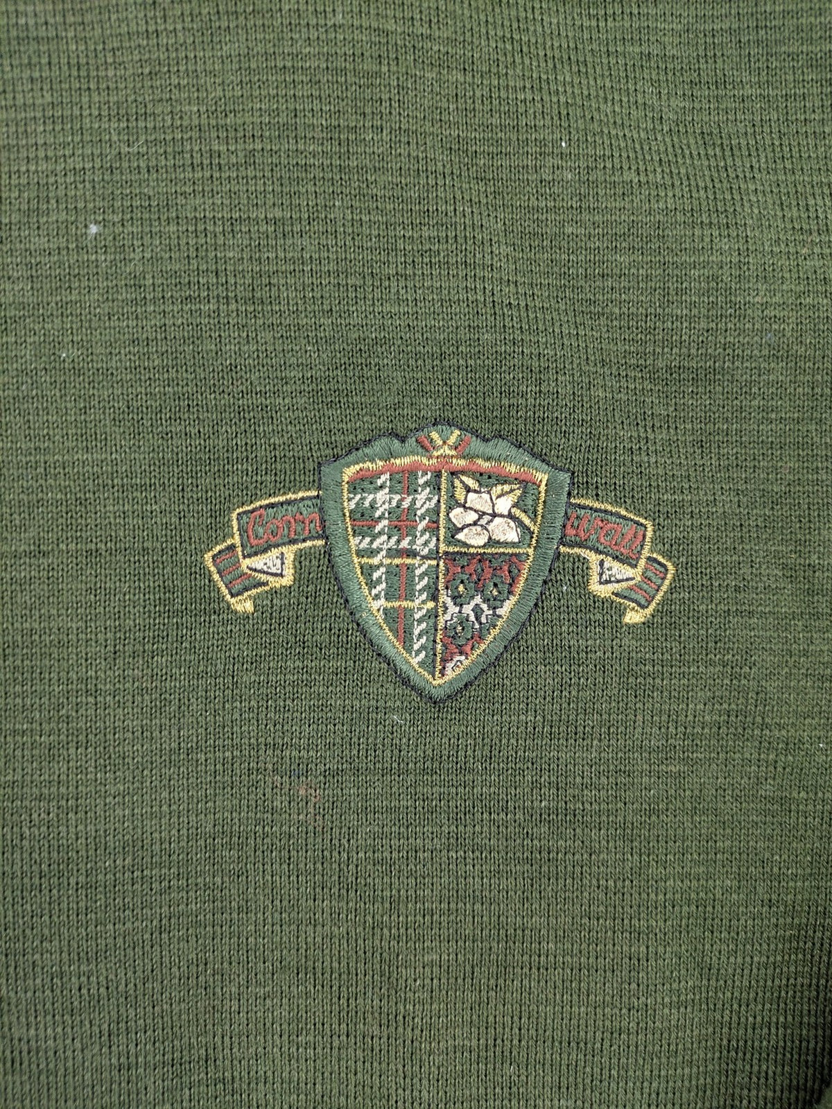 LUCIA green Trachtenjacke with embroidered crest, quilted collar, and decorative buttons.