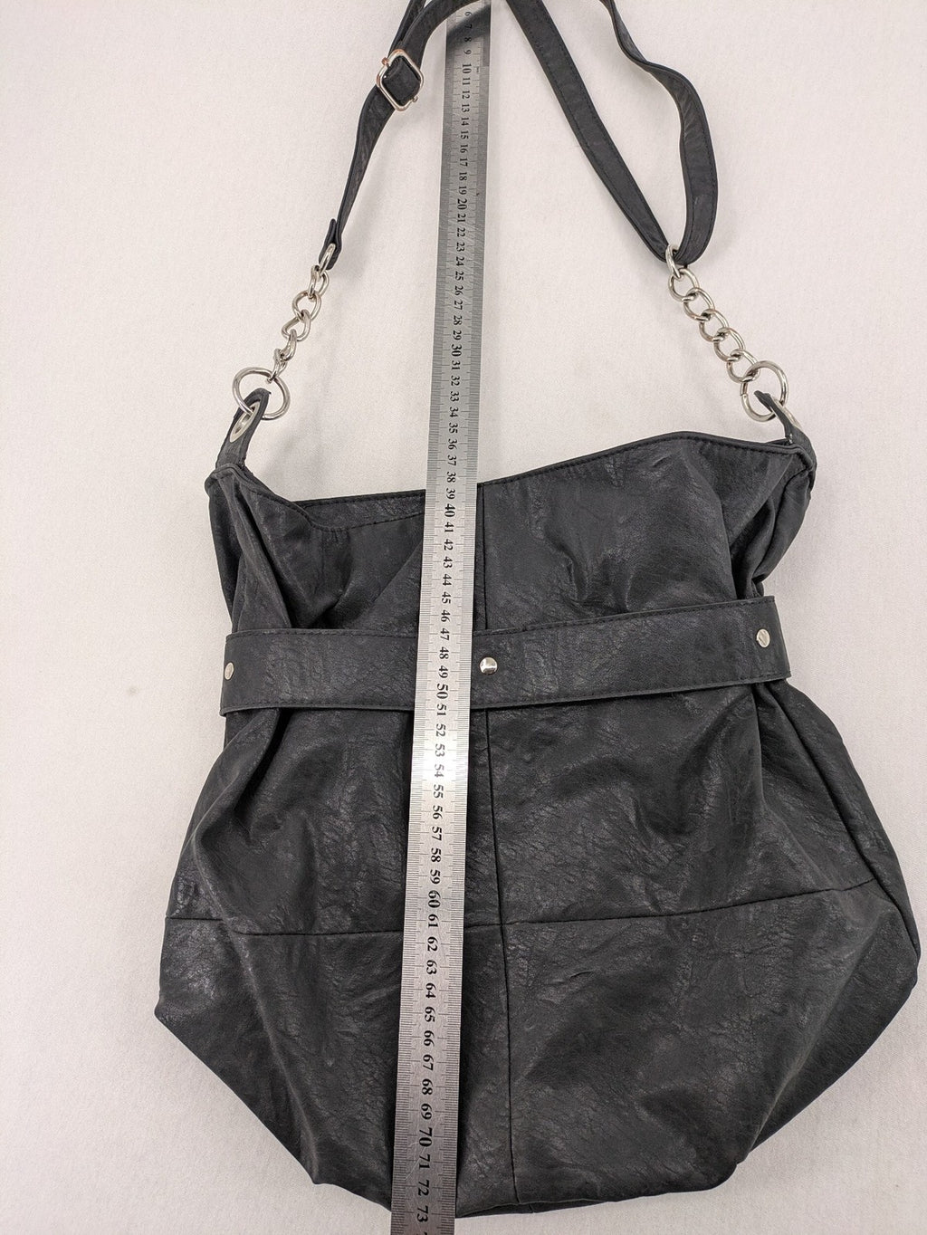 New Yorker black hobo handbag with silver chain details and large eyelets.