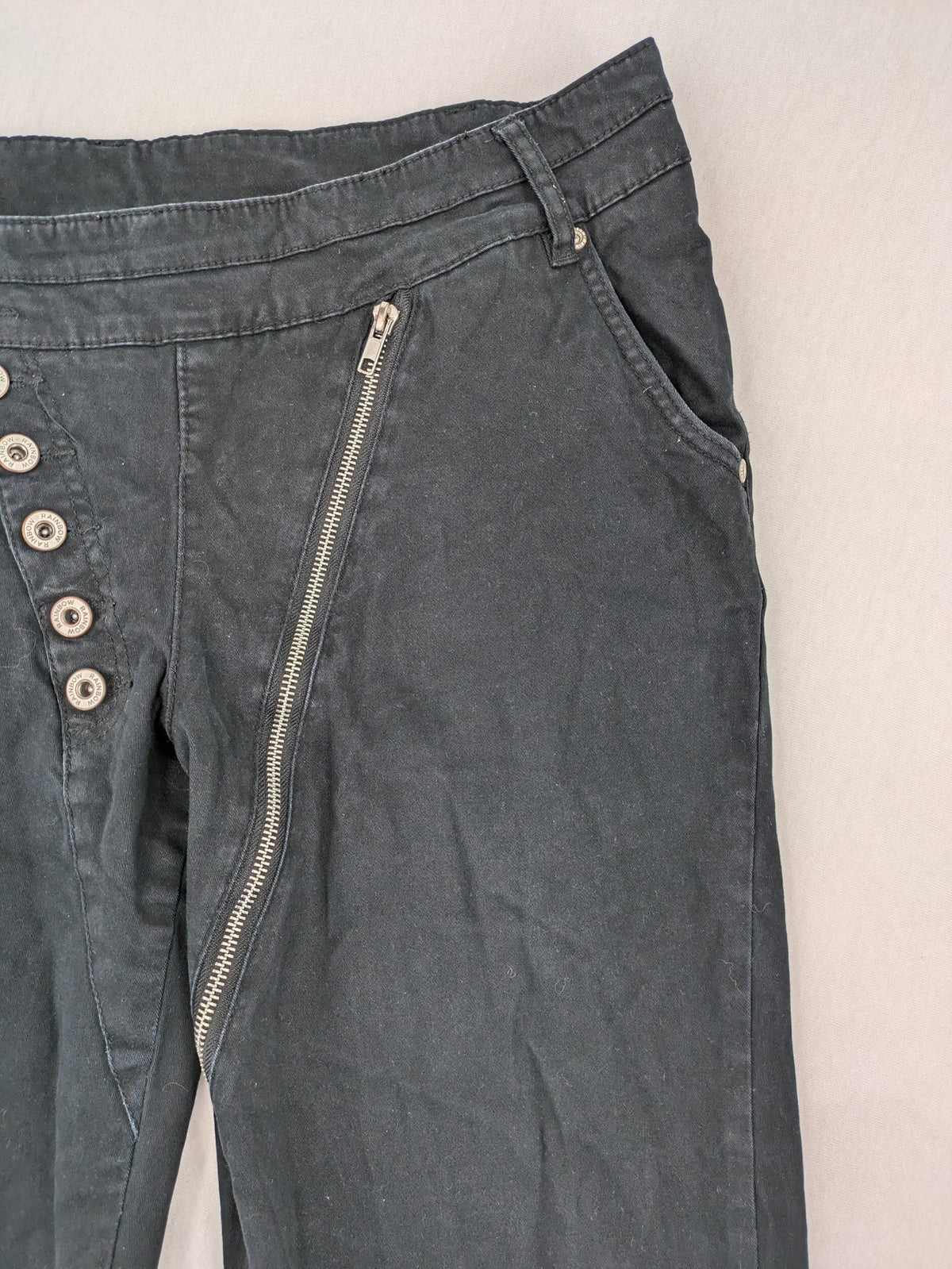 REI grey pants asymmetrical design with diagonal zipper and button placket, cotton blend.