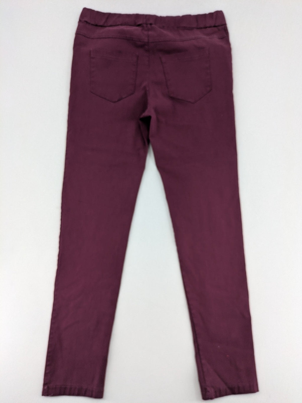 Pink Cherry pants pink stretchy fabric with decorative buttons and elastic waistband.