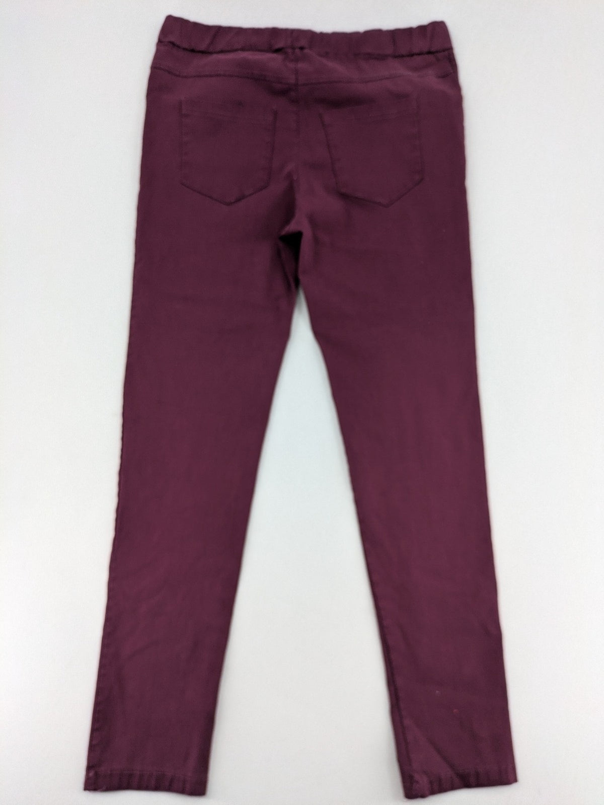 Pink Cherry pants pink stretchy fabric with decorative buttons and elastic waistband.