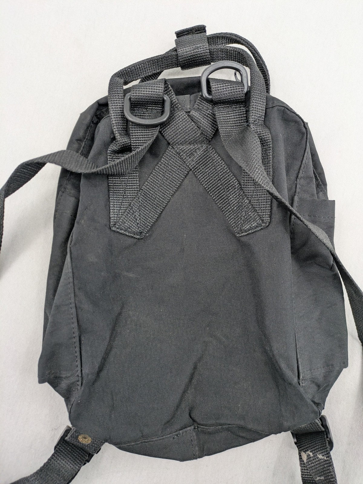 Fjällräven Kånken Mini rucksack black durable fabric with logo and zippered main compartment.