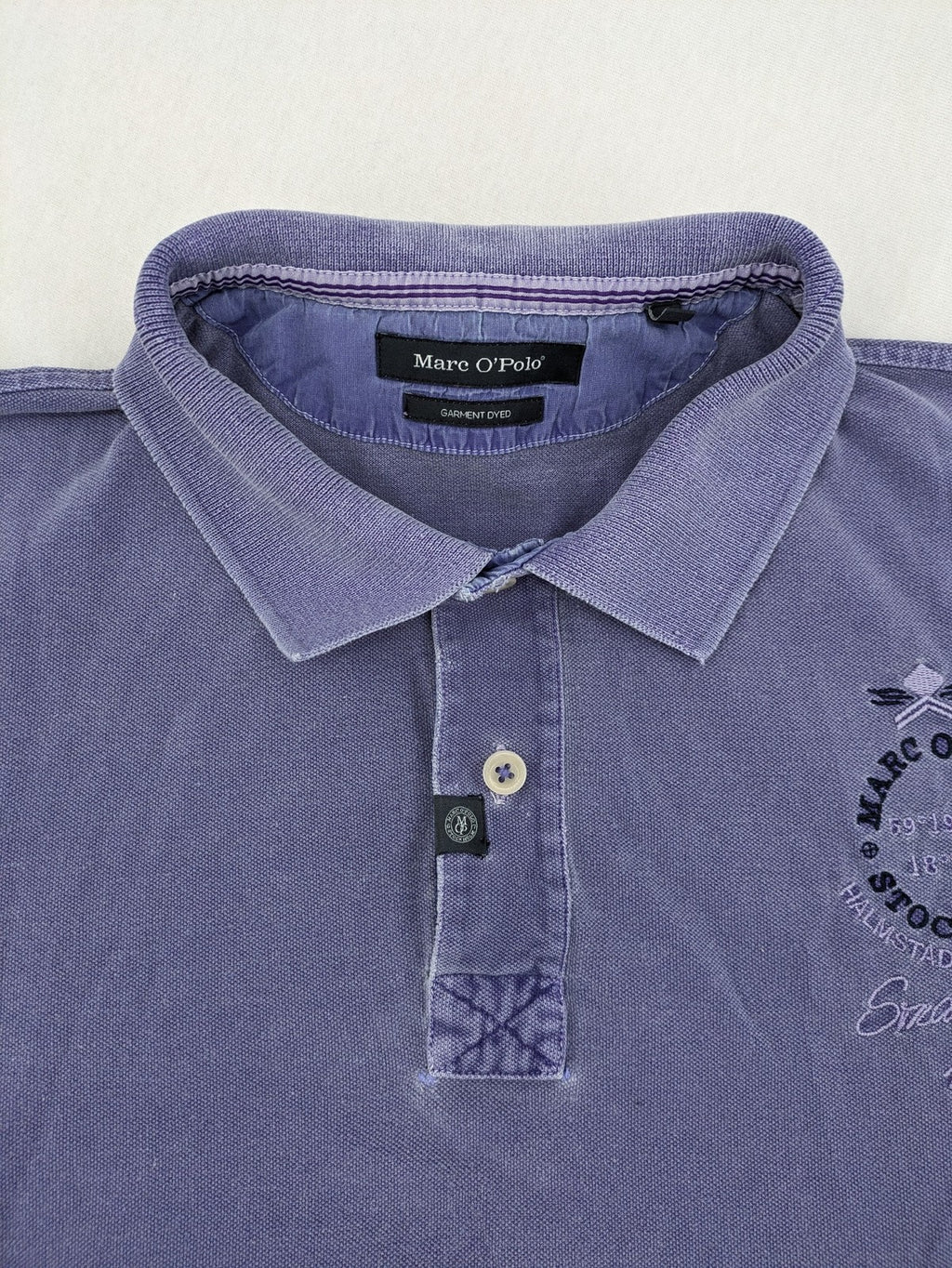 Marc O'Polo purple polo shirt garment dyed cotton with embroidered logo and intricate details.