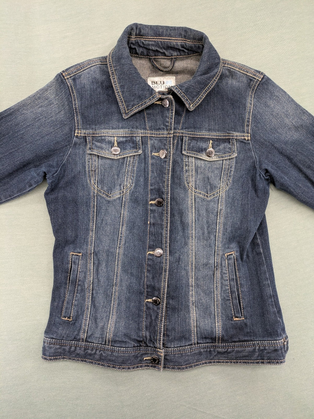 BLU blue denim trucker jacket with button placket and two chest pockets.