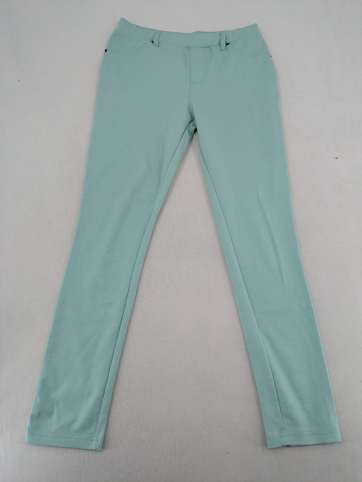Dito green treggings with pull-on design, front pockets, and belt loops.