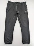 K1X grey joggers with white basketball logo, elastic waistband, and cuffed ankles.