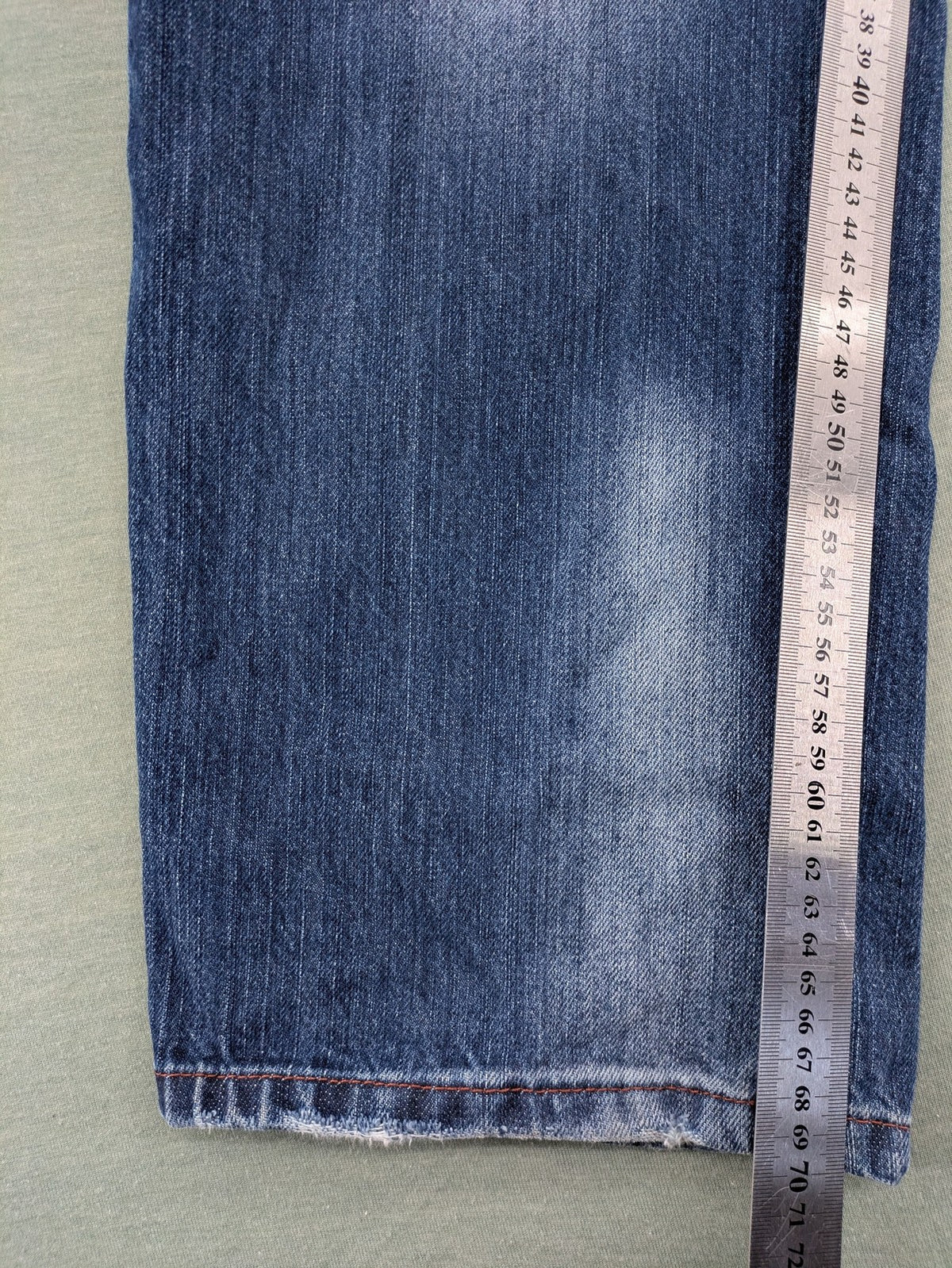 Y2K blue straight jeans with colorful logo embroidery and baggy fit.