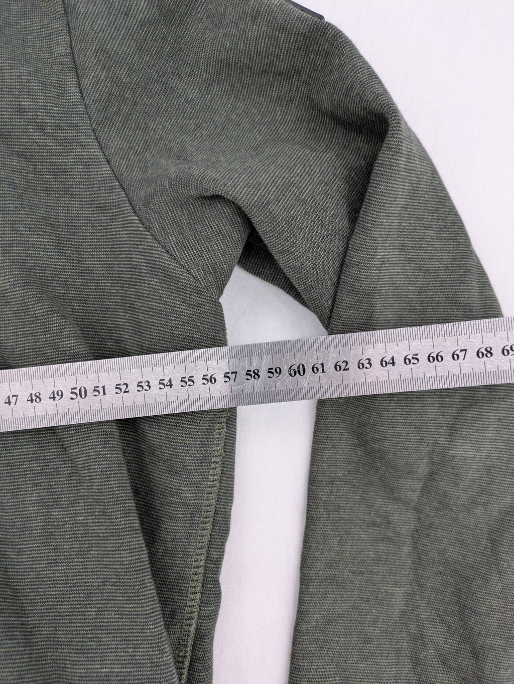 Roadsign Australia green hoodie with mountain graphic print and logo patch on sleeve.