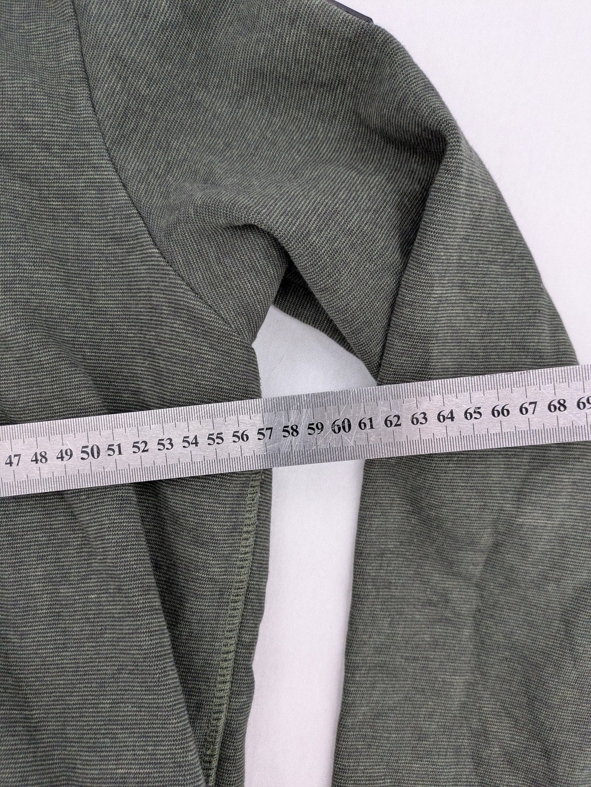 Roadsign Australia green hoodie with mountain graphic print and logo patch on sleeve.