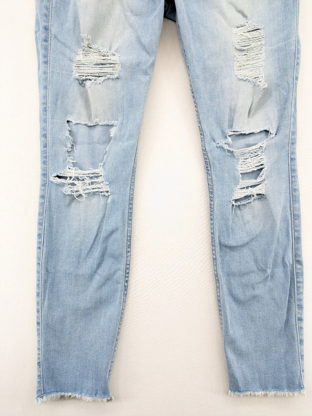 Hollister blue high-rise crop super skinny jeans with distressed rips and frayed hem.