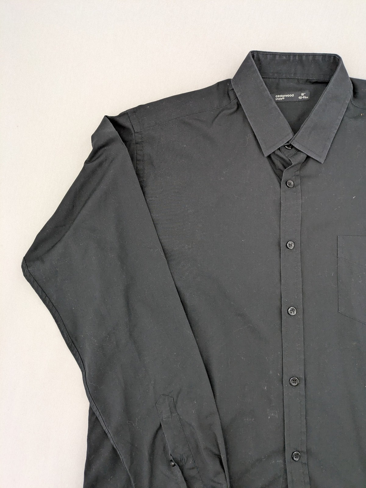 Cedarwood State black long sleeve shirt with classic collar and chest pocket.