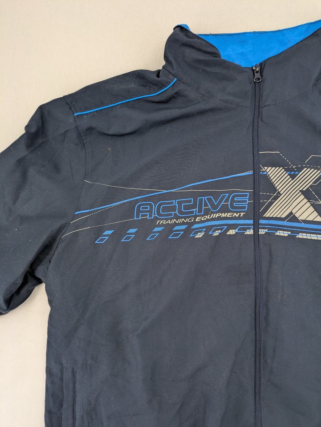 Atlas for Men blue windbreaker jacket with XTREM TECH SPORT graphic print and full zip.