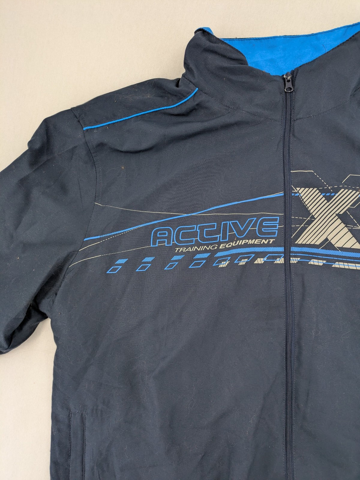 Atlas for Men blue windbreaker jacket with XTREM TECH SPORT graphic print and full zip.