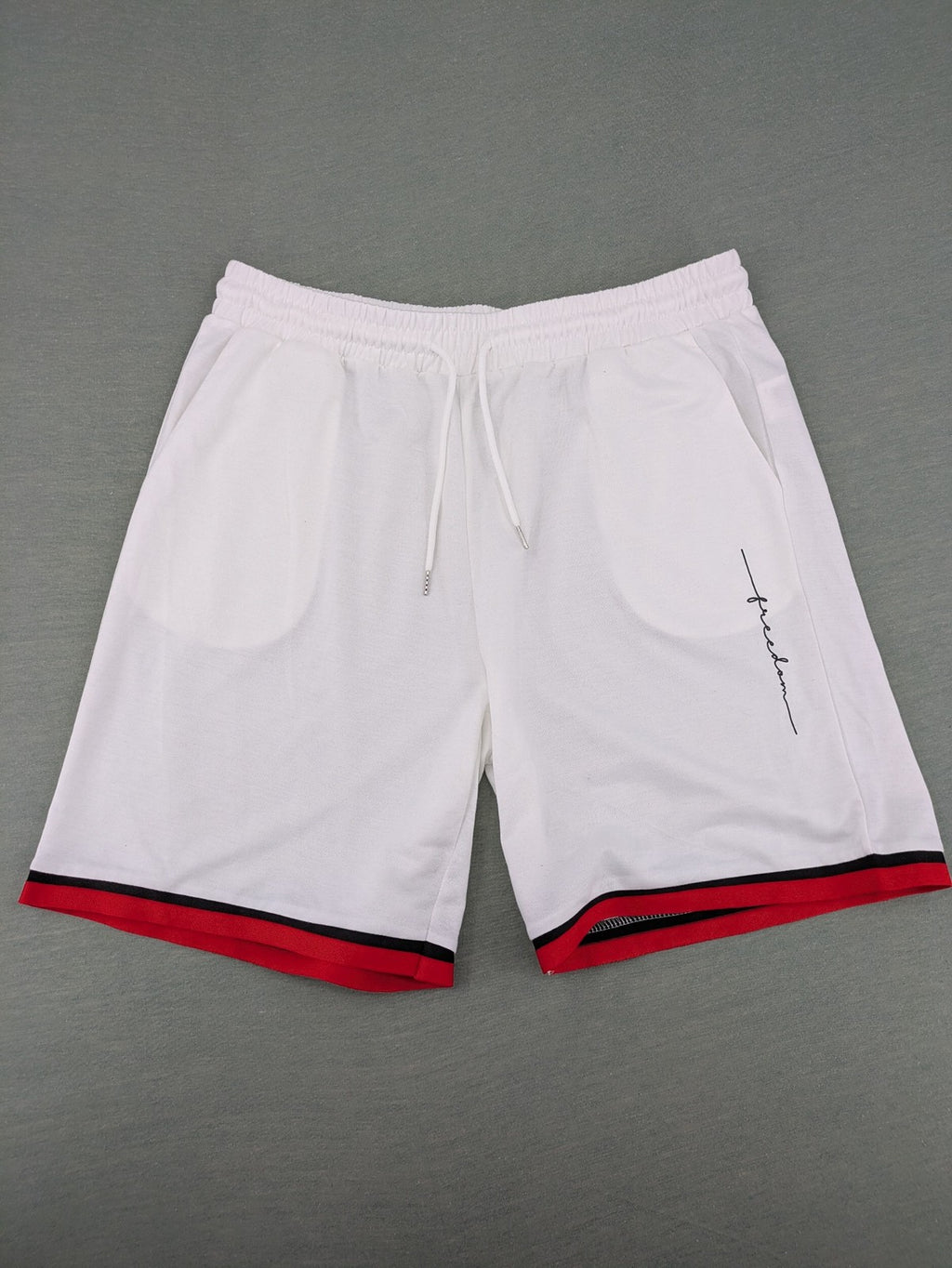 Manfinity black and white outfit set with red accents and "Freedom" graphic print.