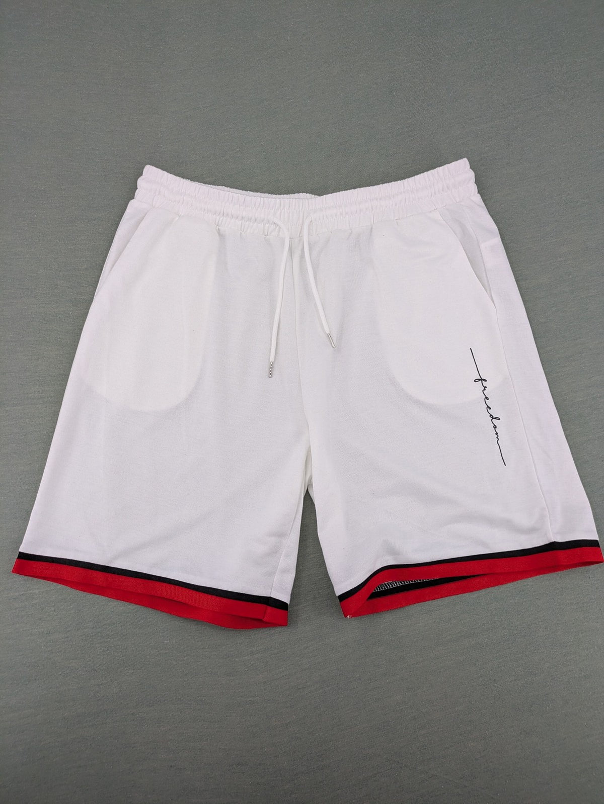 Manfinity black and white outfit set with red accents and "Freedom" graphic print.