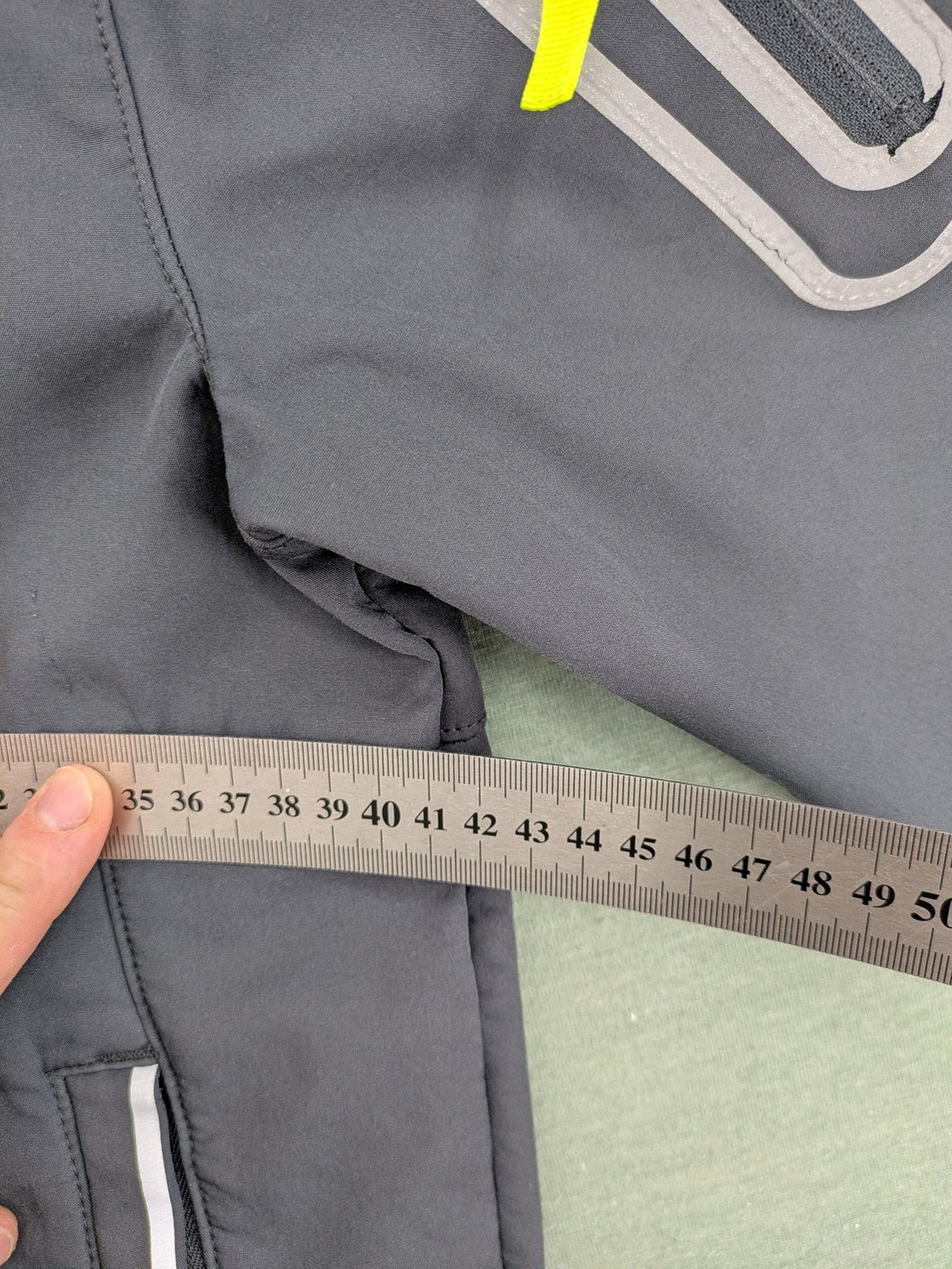 Yigga grey softshell coat with fleece lining, hood, and reflective details.