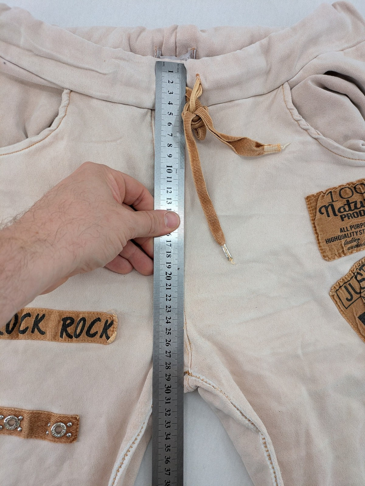 Made In Italy beige pants with crinkle texture and rock-style patches, drawstring waist.