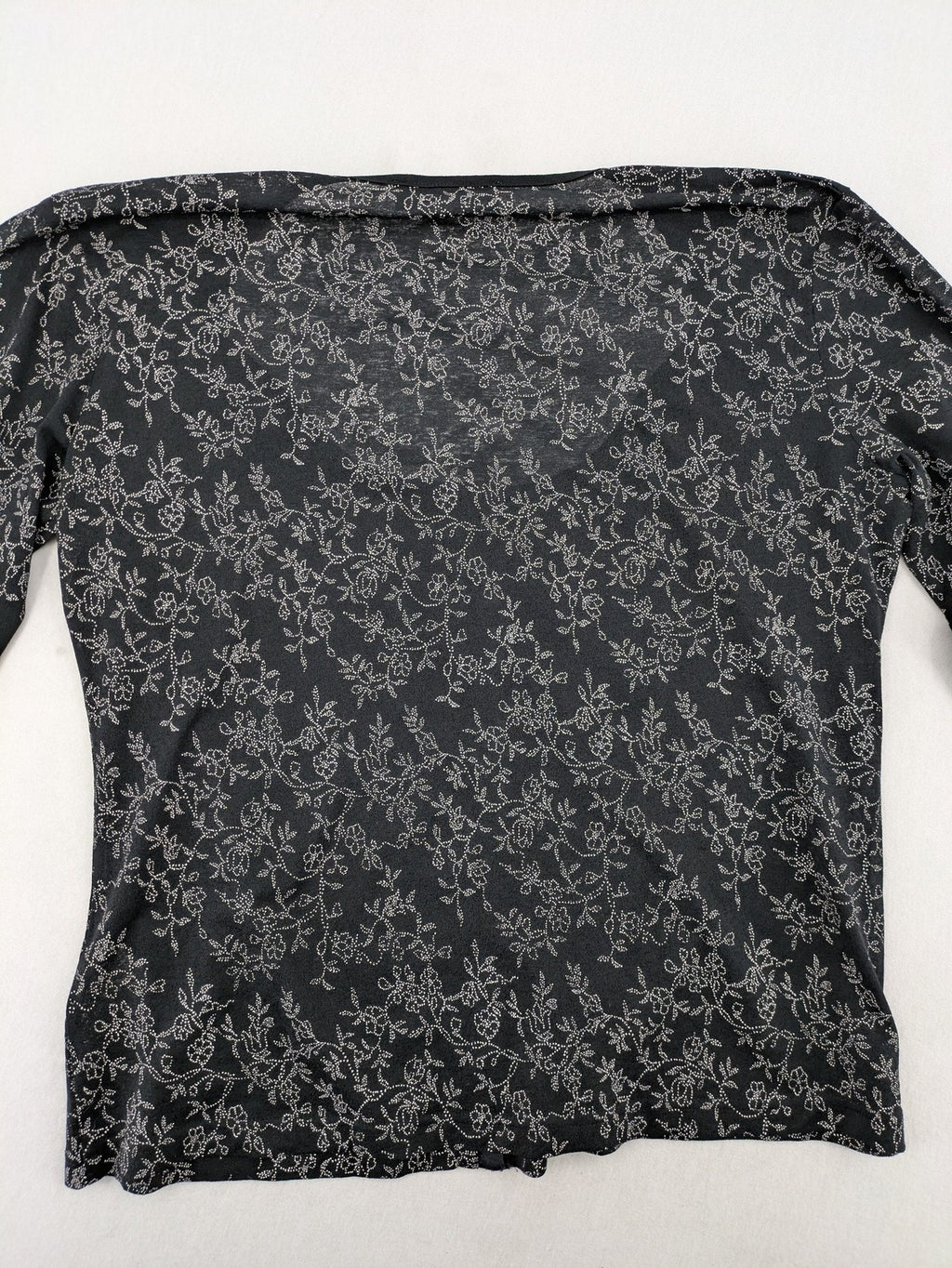Simply The Best black top with white floral pattern and gathered front detail.