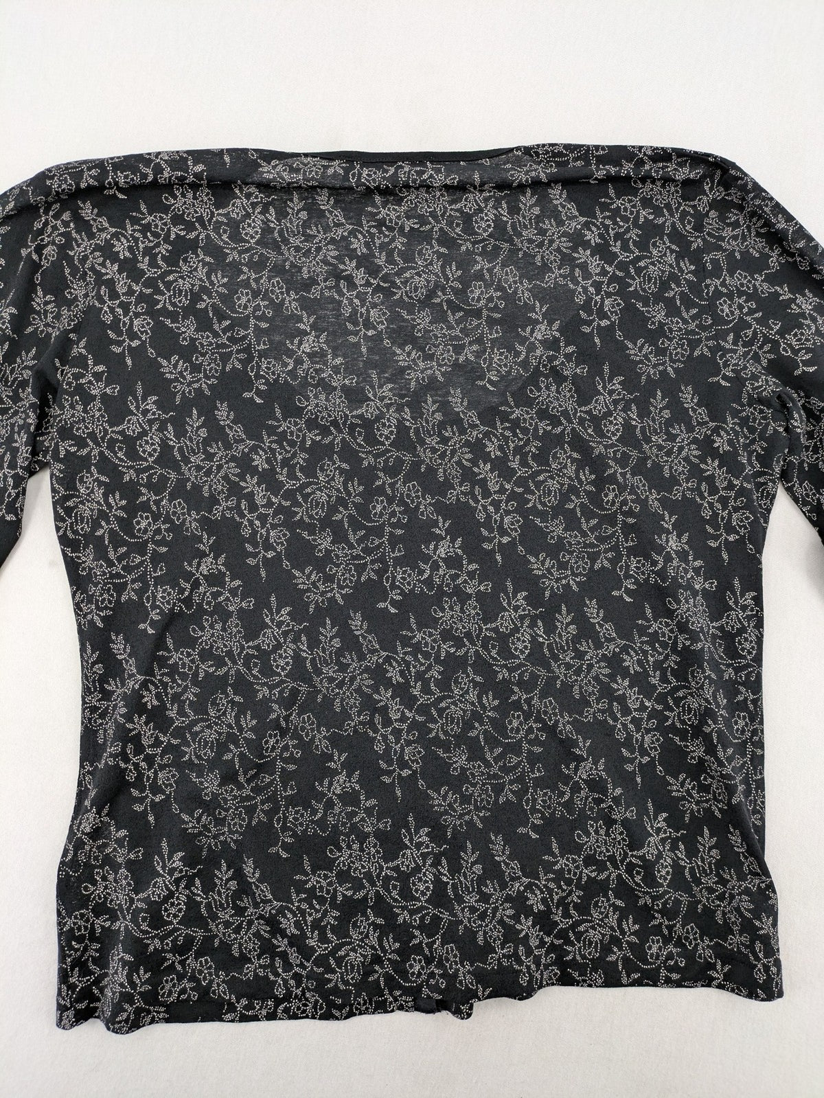 Simply The Best black top with white floral pattern and gathered front detail.